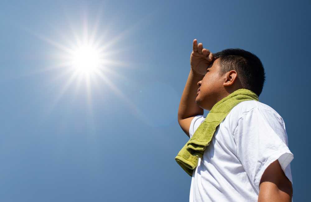 A person looking up at the sun